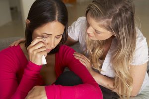 woman consoling distressed friend