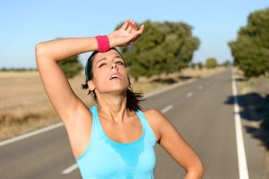 tired woman on a run overheating